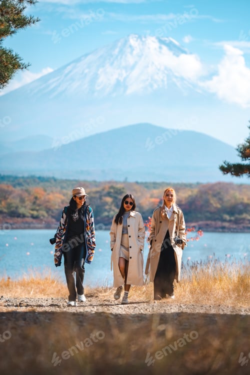 Preview: Happy tourist traveler woman or man enjoying on lake kawaguchiko with mount fuji in japan