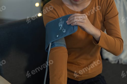 Preview: Woman Taking Blood Pressure Reading at Home