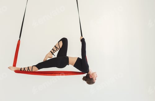 Woman Suspended in Aerial Yoga Pose