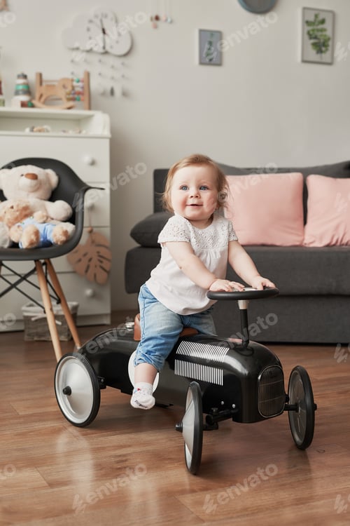 Preview: Sweet funny baby in children room. Scandi style girl room. Child play with educational toys