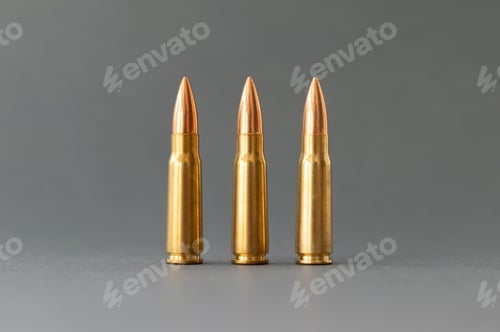 Preview: Three bullets on gray background. Cartridges 7.62 caliber for Kalashnikov assault rifle closeup