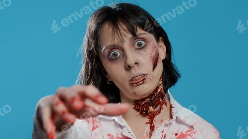 Preview: Undead zombie woman with bloody and deep wounds on neck prowling at camera