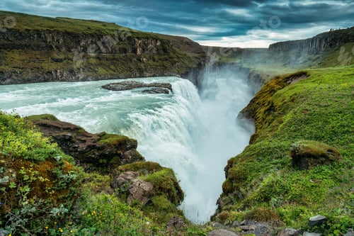Preview: Gullfoss powerful waterfall flowing from Hvita river and moody sky in summer at Iceland