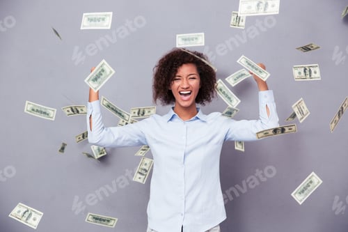 Preview: Concept Photo Of A Cheerful Afro American Woman Standing Under Rain With Money On Gray Background