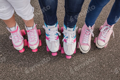 Preview: Mother and her two daughters on roller skates, partial view