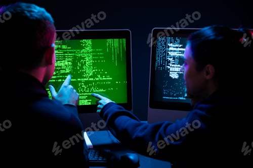 Preview: Caucasian man and a woman working late in an office
