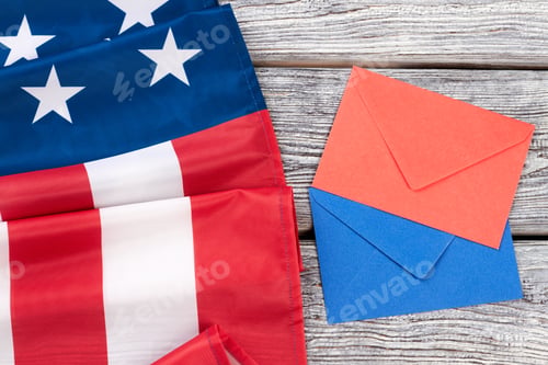 Preview: Folded American flag and two envelopes.