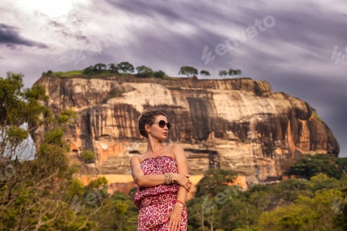 Preview: Portrait woman in sunglasses posing in front Sigiriya rock fortress at Sri Lanka