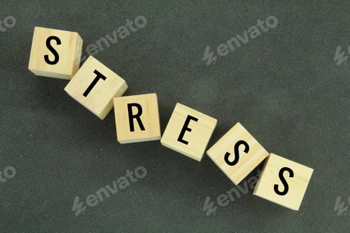 Preview: stacked wooden cubes strewn with the word stress