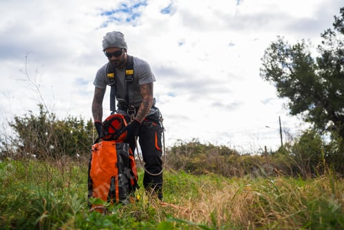 Preview: Rope access technician preparing for tree pruning