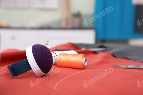 Preview: Fabric and sewing tools on table in tailor workshop, closeup