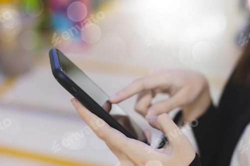 Preview: Close-up female hand using smartphone at meeting room blur bokeh background.