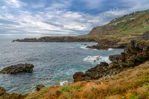 Preview: View of El Sauzal coastline in Tenerife with rocky shores, ocean waves, and lush hillsides