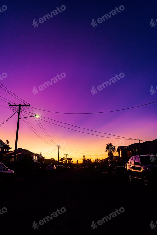 Preview: Silhouette of houses and cars with a scenery of sunset and a beautiful sky in the background