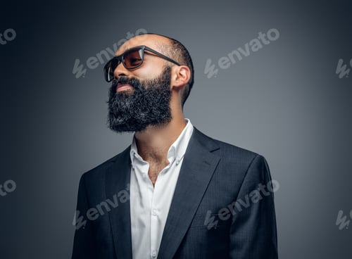 Preview: Bald head male dressed in a suit and sunglasses.