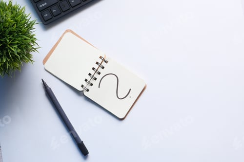 Preview: high angle view of question mark on notepad