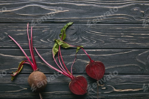 Preview: Small red beetroots on dark wooden table