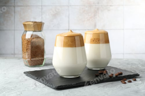 Preview: Delicious dalgona coffee in glasses, beans and granules on grey table
