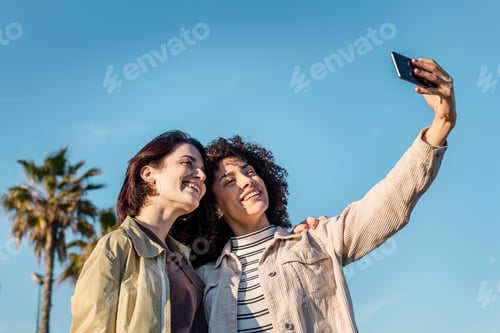 Preview: two girls taking selfie with a mobile phone