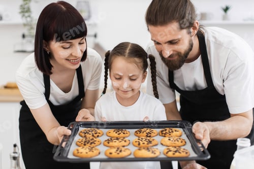 Preview: Caucasian family enjoying cookie baking together in kitchen