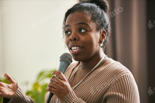 Preview: Speaking at Public Event Holding Microphone