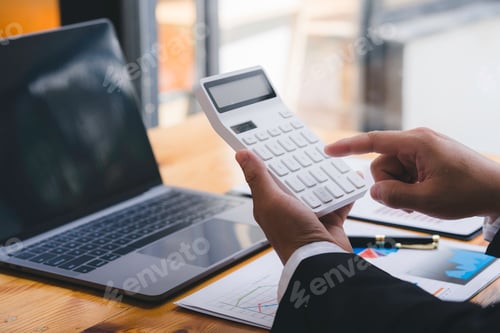 Preview: Businessman working on desk with using calculator and computer in the office. concept accounting fin