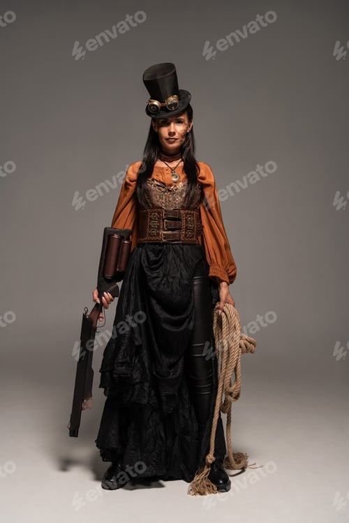 Preview: full length view of attractive steampunk woman holding guy and lasso on grey