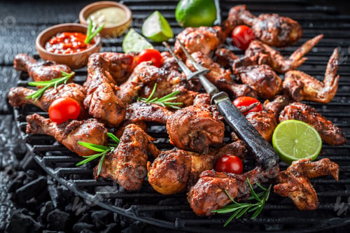 Preview: Spicy grilled chicken leg on metal grate