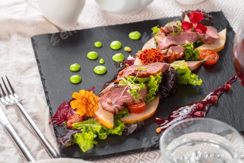 Preview: Tasty sliced roast duck breast with fresh vegetable salad closeup on a plate