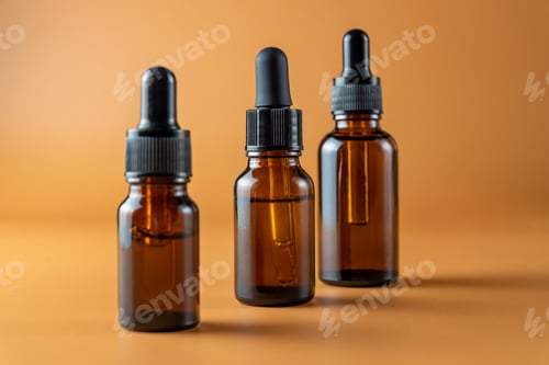 Preview: Set of brown glass bottles with essential oil on a beige background. Packaging of a beauty product