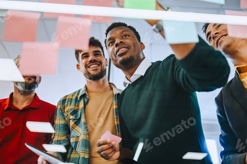 Preview: Portrait of a diverse coworkers analyzing tactic while looking at sticky notes.