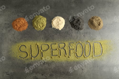 Preview: Word Superfood and different healthy powders on grey table, flat lay