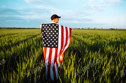 Preview: Man hold waving american USA flag. Patriot raise national american flag. Independence Day, 4th July.