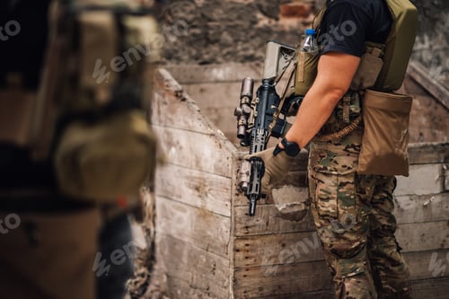 Preview: Cropped picture of soldier holding sniper rifle in ruins.
