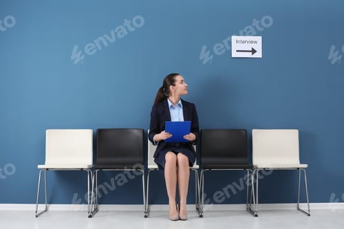 Preview: Young woman waiting for job interview, indoors