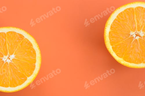Preview: Top view of a several orange fruit slices on bright background in orange color