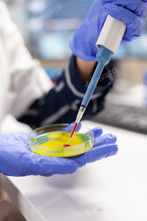 Preview: Close up of doctor dropping blood sample using micropipette