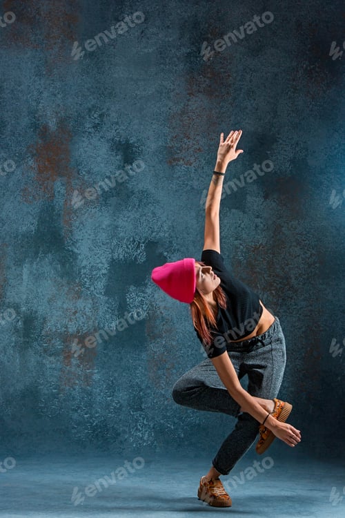 Preview: Young girl break dancing on wall background.