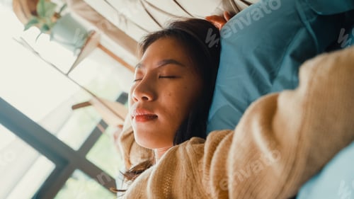 Preview: Girl lay head down on pillow close eyes happy smiling feel comfortable on bed in bedroom.