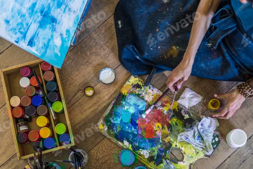 Preview: High angle view of brushes, pallete, oils, acrylics and other elements of a painter artist.