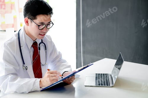 Preview: Doctor working on his laptop with medical equipment at hospital.