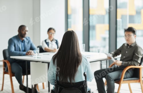 Preview: Businesswoman in Wheelchair Attending Meeting