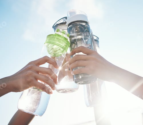 Preview: Hands, water bottle and toast to fitness together after workout, exercise or training outdoor with