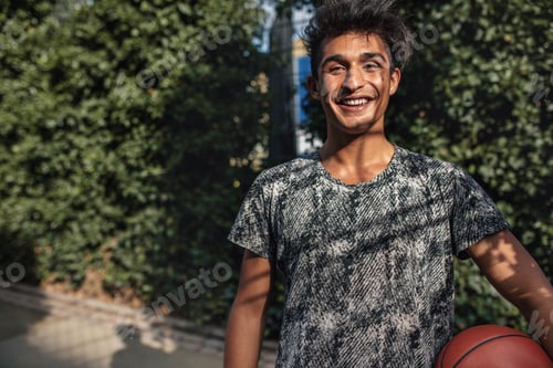Preview: Happy teenage streetball player on court