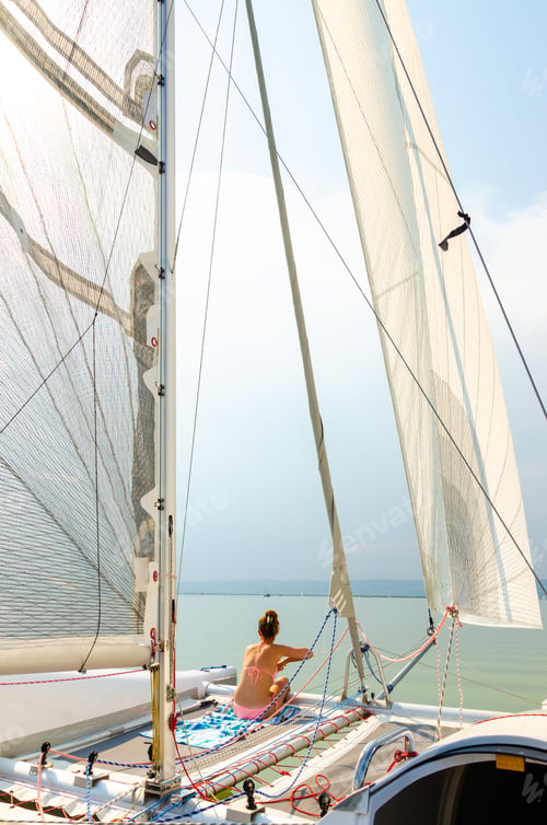 Preview: Girl on a catamaran boat sailing through neusiedler lake