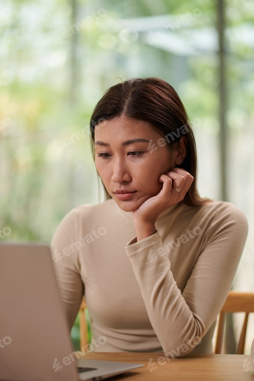 Preview: Businesswoman Reading E-mails on Laptop