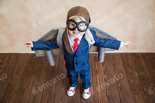 Preview: Portrait of young businessman with toy paper wings