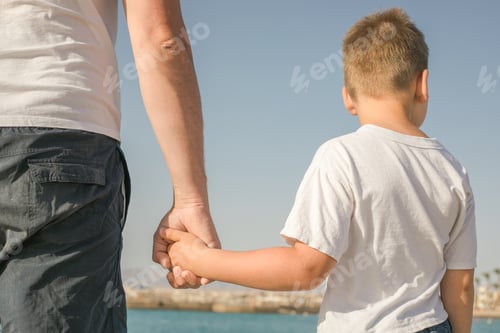 Preview: Father and son spending time together sea vacation walking beach. Happy childhood with daddy.