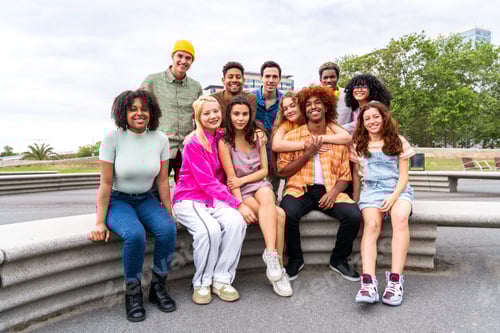 Preview: Happy playful multiethnic group of young friends bonding outdoors