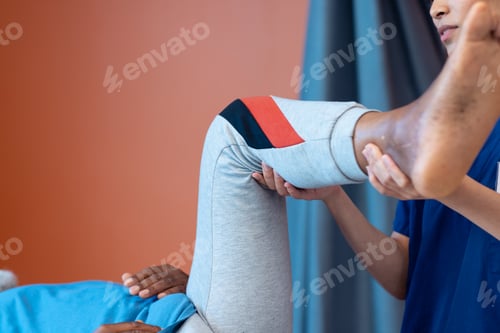Preview: Medical Professional Assisting Senior with Leg Raise